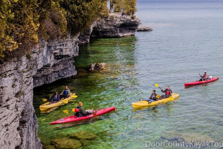 Kayakers paddling toward Cave Point in Wisconsin