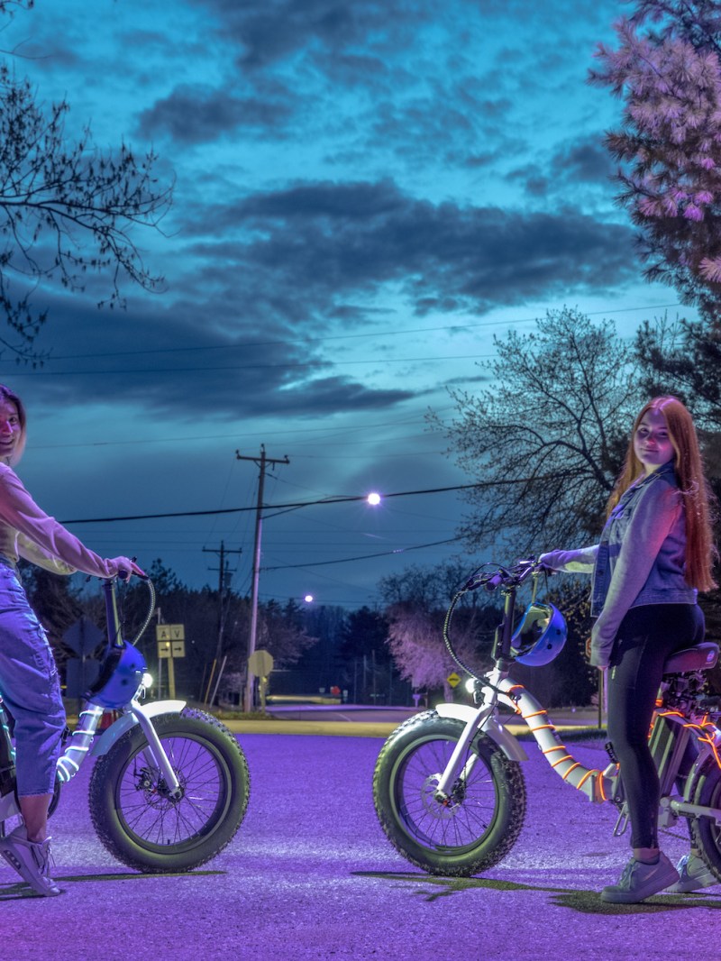 a group of people riding on the back of a bicycle
