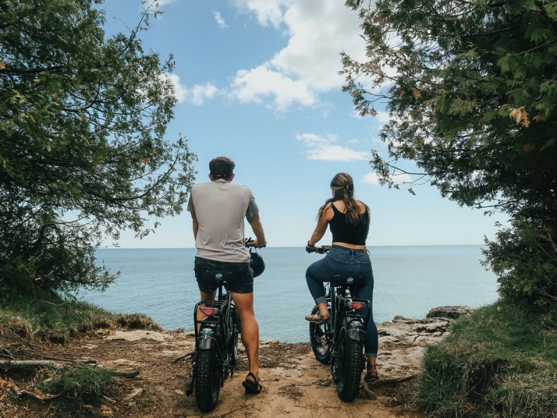 a person riding a motorcycle down a dirt road