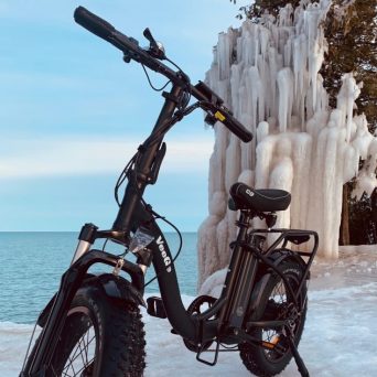 A E-bike at Cave Point in Winter with ice parked in the snow on a bike tour