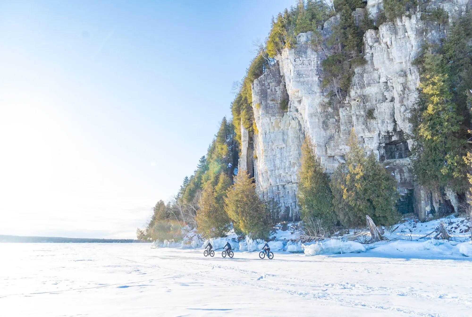 eagle-bluff-ice-fat-tire-e-bike-tour a group of people fat tire ebike tours in front of eagle bluff