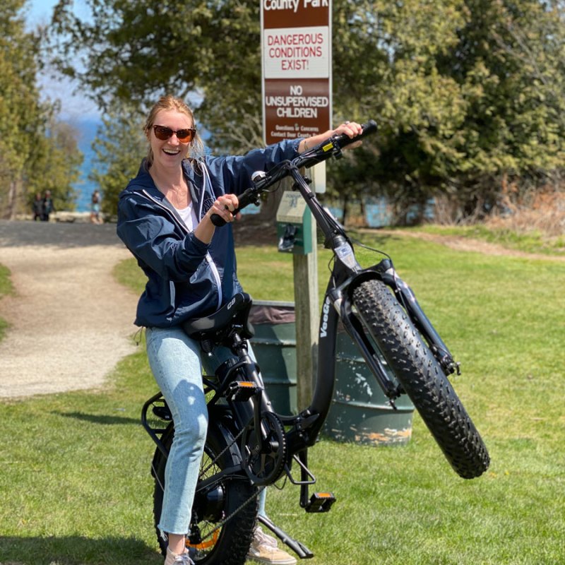 a person standing next to a motorcycle