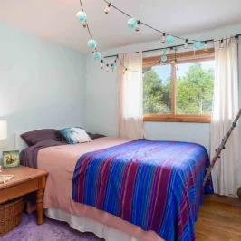 a bedroom with a bed and desk in a small room