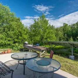 a couple of lawn chairs sitting on top of a picnic table