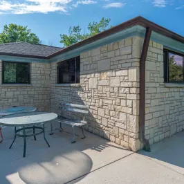 a bench in front of a brick building