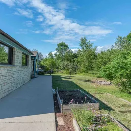 a large brick building with grass and trees