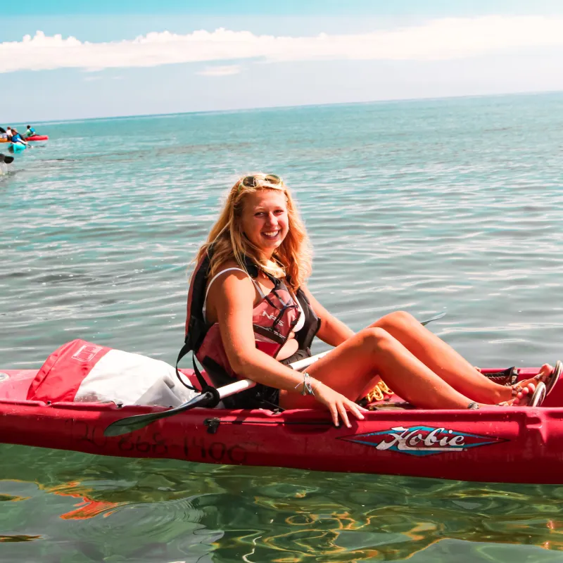 a person riding on the back of a boat in a body of water