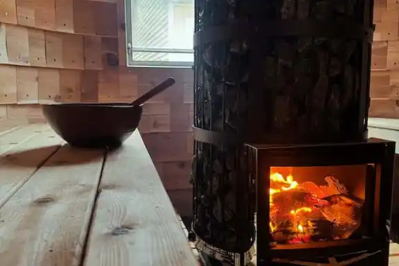 a fire place sitting in front of a brick oven