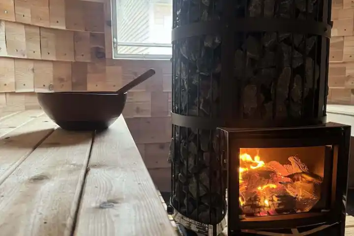 a fire place sitting in front of a brick oven